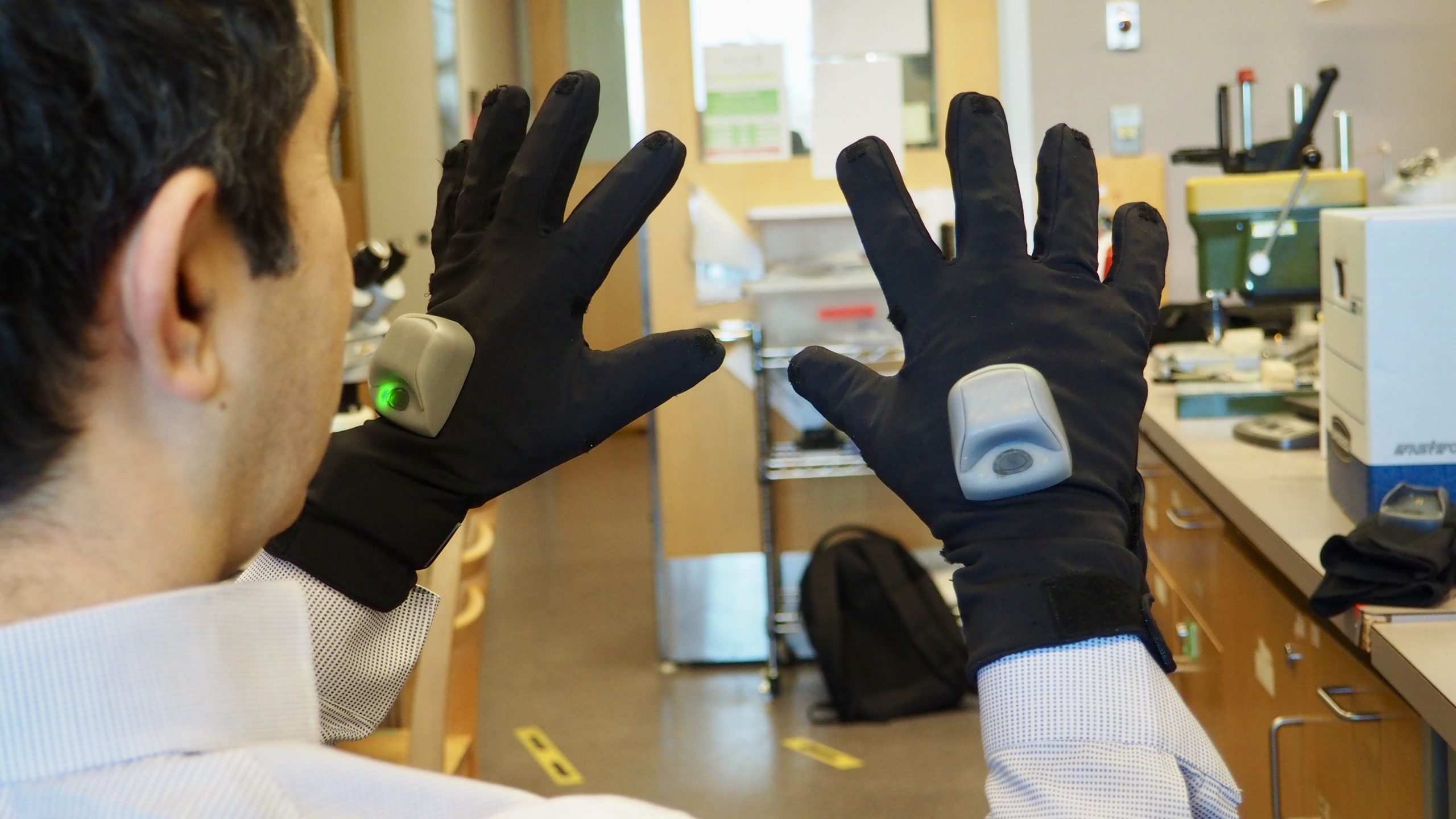 UBC electrical and computer engineering professor Dr. Peyman Servati demonstrating the smart glove. Photo credit: Lou Bosshart/UBC Media Relations